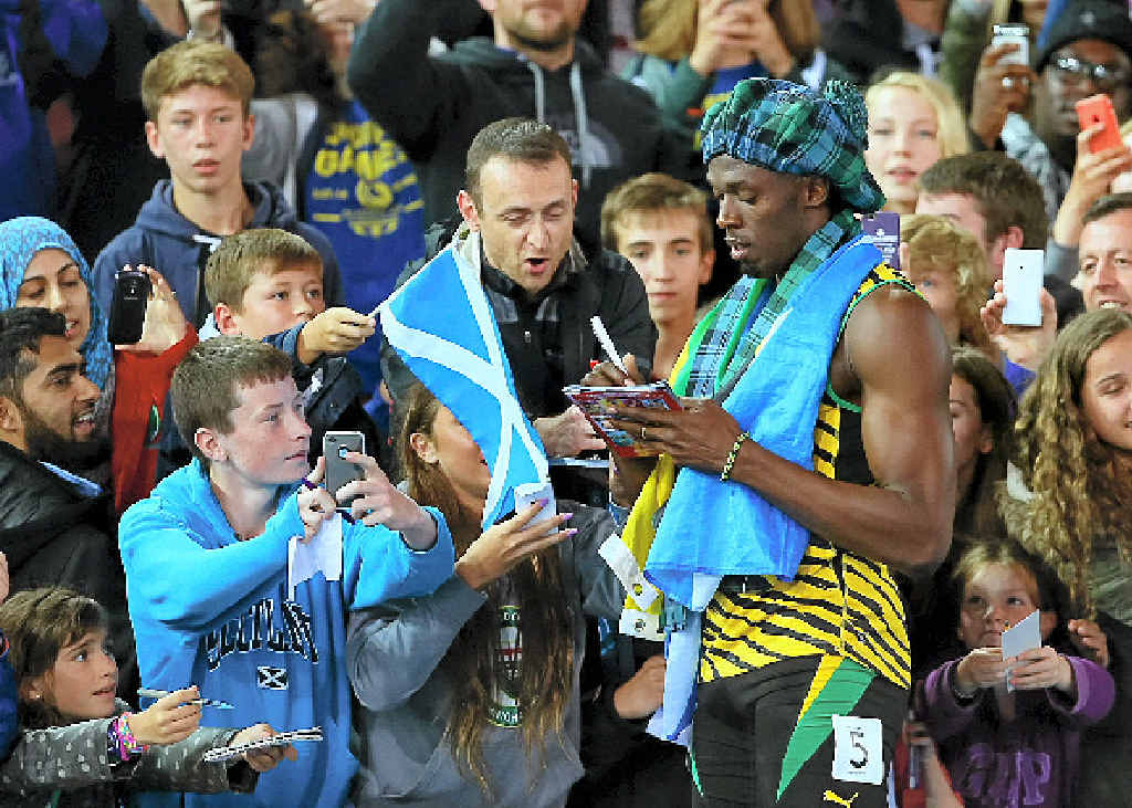 Usain Bolt signs autographs after winning gold in the men’s 4x100 metres at Hampden Park wearing a tam o’shanter. Usain Bolt signs autographs after winning gold in the men’s 4x100 metres at Hampden Park wearing a tam o’shanter.