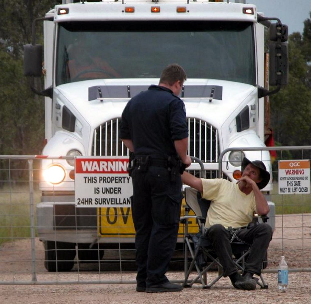 Tara resident Graeme Henderson, pictured being arrested for blocking QGC vehicles in 2011, confirms the drilling company has been buying up land from outspoken CSG opponents in the area. Tara resident Graeme Henderson, pictured being arrested for blocking QGC vehicles in 2011, confirms the drilling company has been buying up land from outspoken CSG opponents in the area.