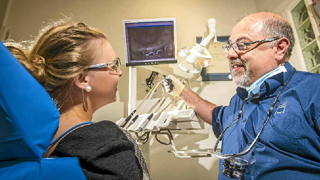 OPEN WIDE: Remo Fanelli of Fanelli Dental with a patient. Dr Fanelli says the low dose provided by water fluoridation helps everyone. OPEN WIDE: Remo Fanelli of Fanelli Dental with a patient. Dr Fanelli says the low dose provided by water fluoridation helps everyone.