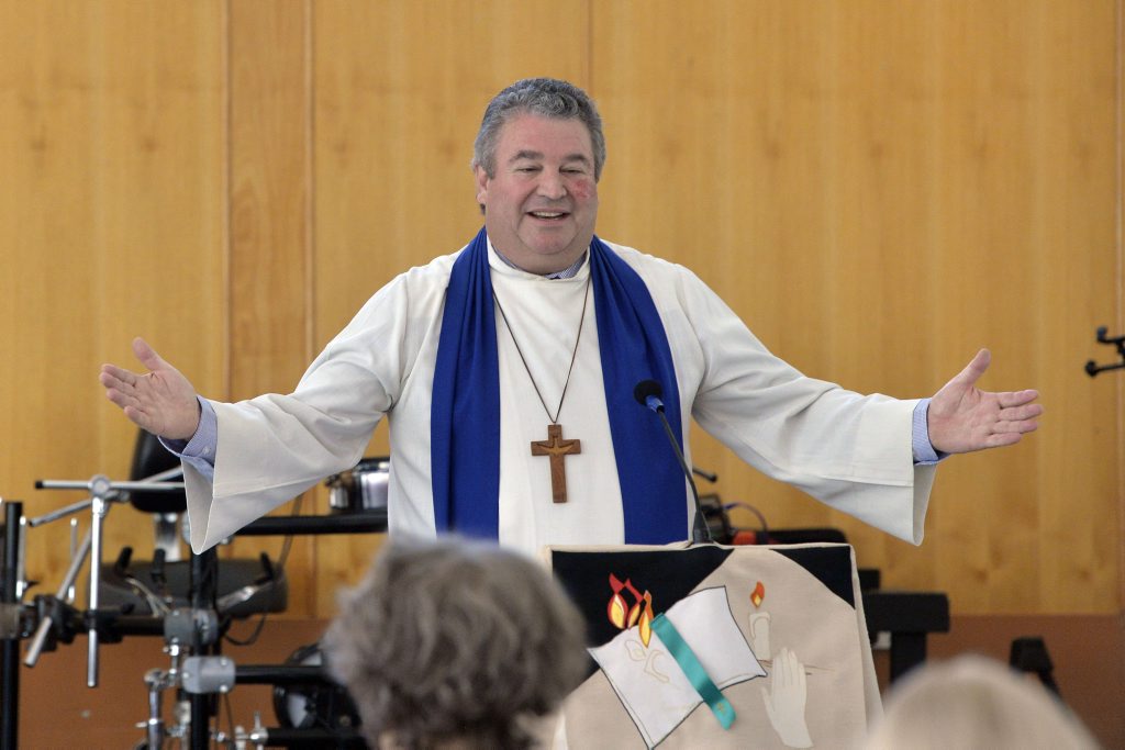 The Reverend Peter Arnett addresses the congregation. The Reverend Peter Arnett addresses the congregation.