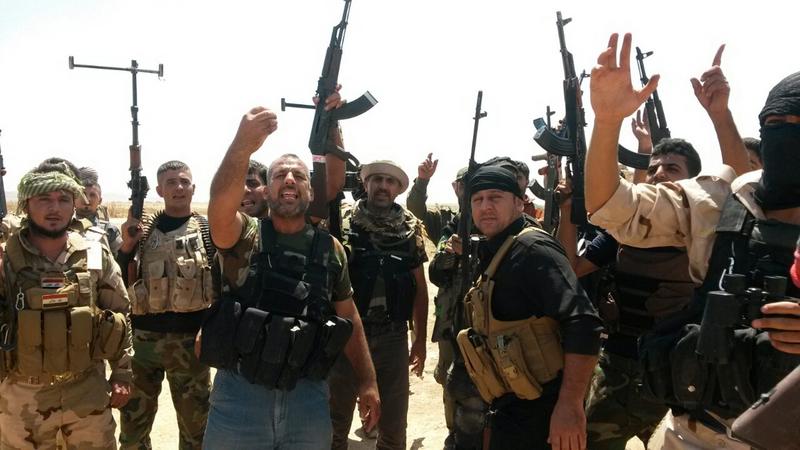 Soldiers of the Kurdish Peshmerga forces and Shiite volunteers take position during fighting with Islamic State (IS) fighters, in Amerly town, northeastern Baghdad, Iraq, 07 August 2014. Soldiers of the Kurdish Peshmerga forces and Shiite volunteers take position during fighting with Islamic State (IS) fighters, in Amerly town, northeastern Baghdad, Iraq, 07 August 2014.