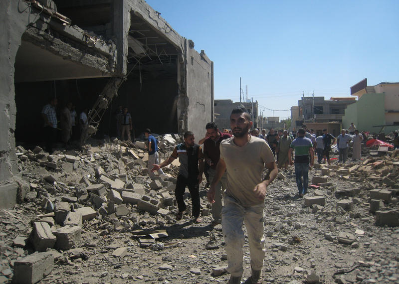 Iraqis inspect the site of a double car bomb attack took place in Kirkuk, 180 miles (290 kilometers) north of Baghdad, Iraq, Thursday, Aug. 7, 2014. Iraqis inspect the site of a double car bomb attack took place in Kirkuk, 180 miles (290 kilometers) north of Baghdad, Iraq, Thursday, Aug. 7, 2014.