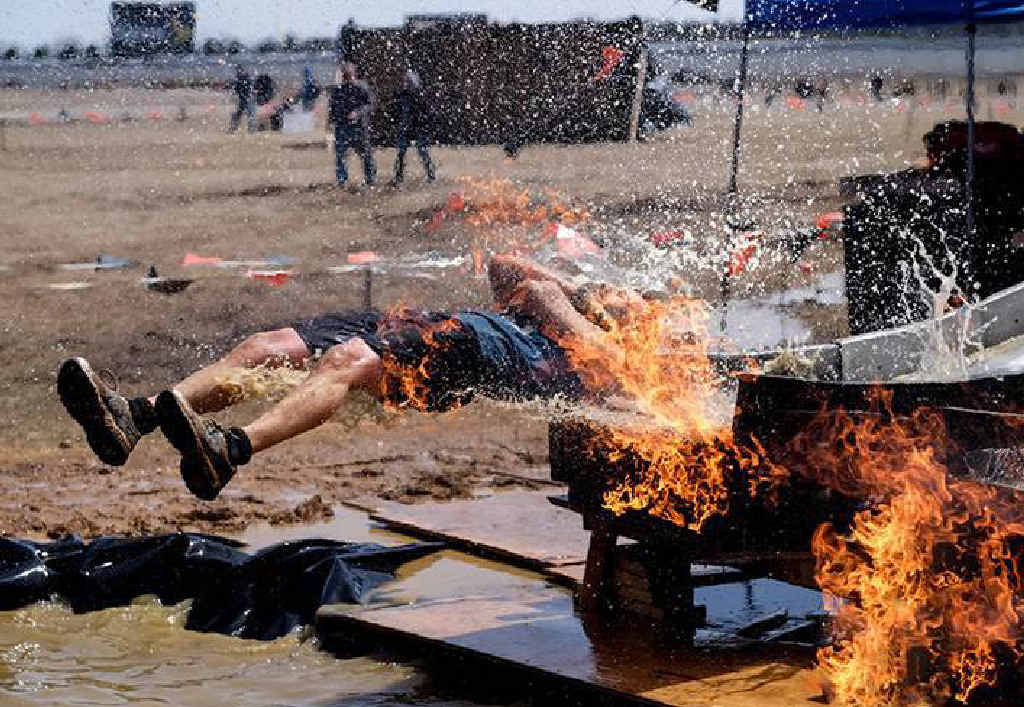 FLAMING CRAZY: Tough Mudder’s new obstacle, Fire In Your Hole, will test veteran Mudders’ resolve. FLAMING CRAZY: Tough Mudder’s new obstacle, Fire In Your Hole, will test veteran Mudders’ resolve.