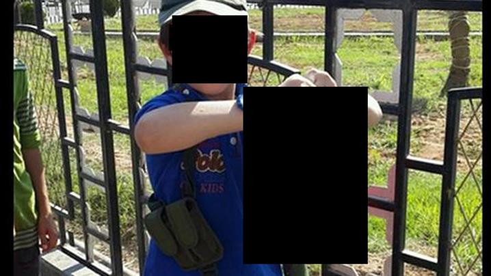 A seven-year-old, believed to be the son of Australian jihadist Khaled Sharrouf, holds the severed head of a Syrian soldier beside the caption, 'That's my boy!' A seven-year-old, believed to be the son of Australian jihadist Khaled Sharrouf, holds the severed head of a Syrian soldier beside the caption, 'That's my boy!'