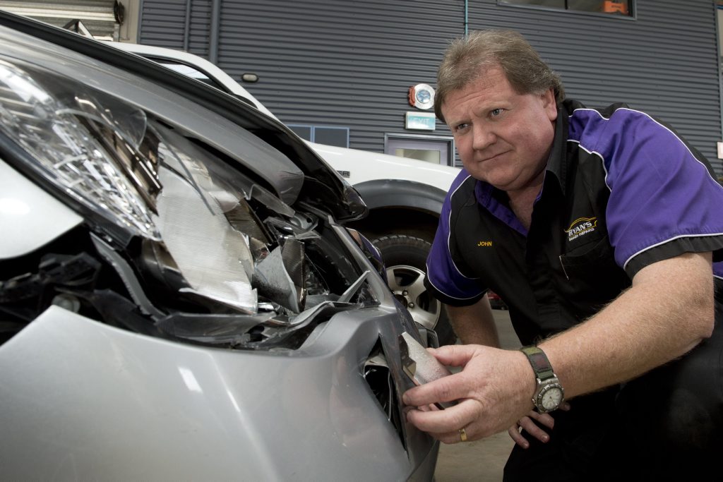 Ryan's Smash Repairs owner John Schriek inspects damage to a Honda sedan caused by a kangaroo or wallaby. Ryan's Smash Repairs owner John Schriek inspects damage to a Honda sedan caused by a kangaroo or wallaby.