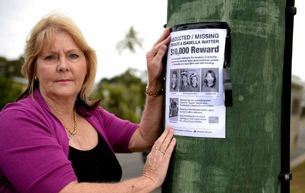 Rae Bichel puts up a poster of missing children. Photo Allan Reinikka / The Morning Bulletin Rae Bichel puts up a poster of missing children. Photo Allan Reinikka / The Morning Bulletin