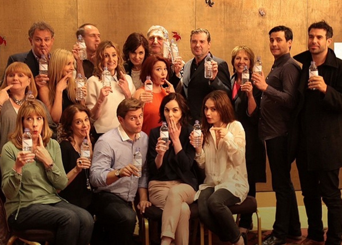 The Downton Abbey cast have made light of the water bottle promo photo gaffe and turned the attention to WaterAid The Downton Abbey cast have made light of the water bottle promo photo gaffe and turned the attention to WaterAid