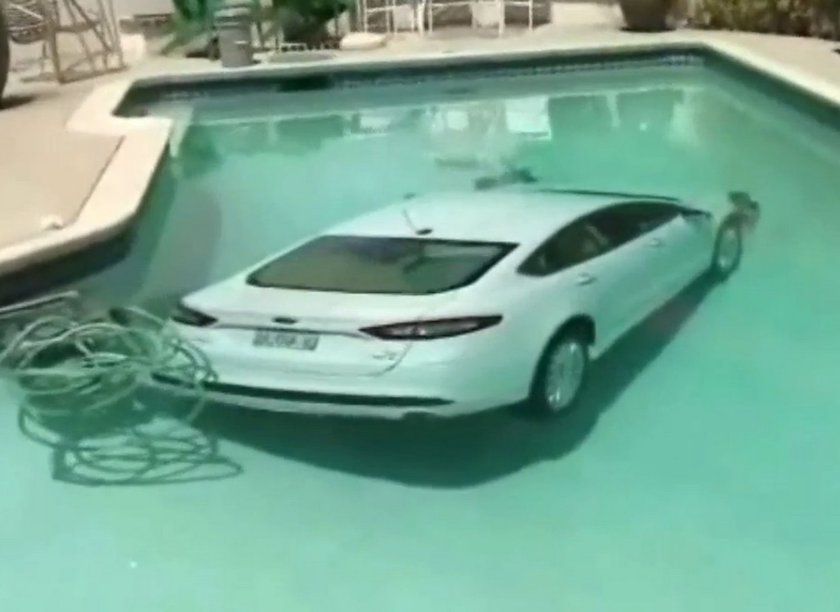 Car lands in backyard swimming pool after 85-year-old man tangles his thongs around the car's pedals Car lands in backyard swimming pool after 85-year-old man tangles his thongs around the car's pedals
