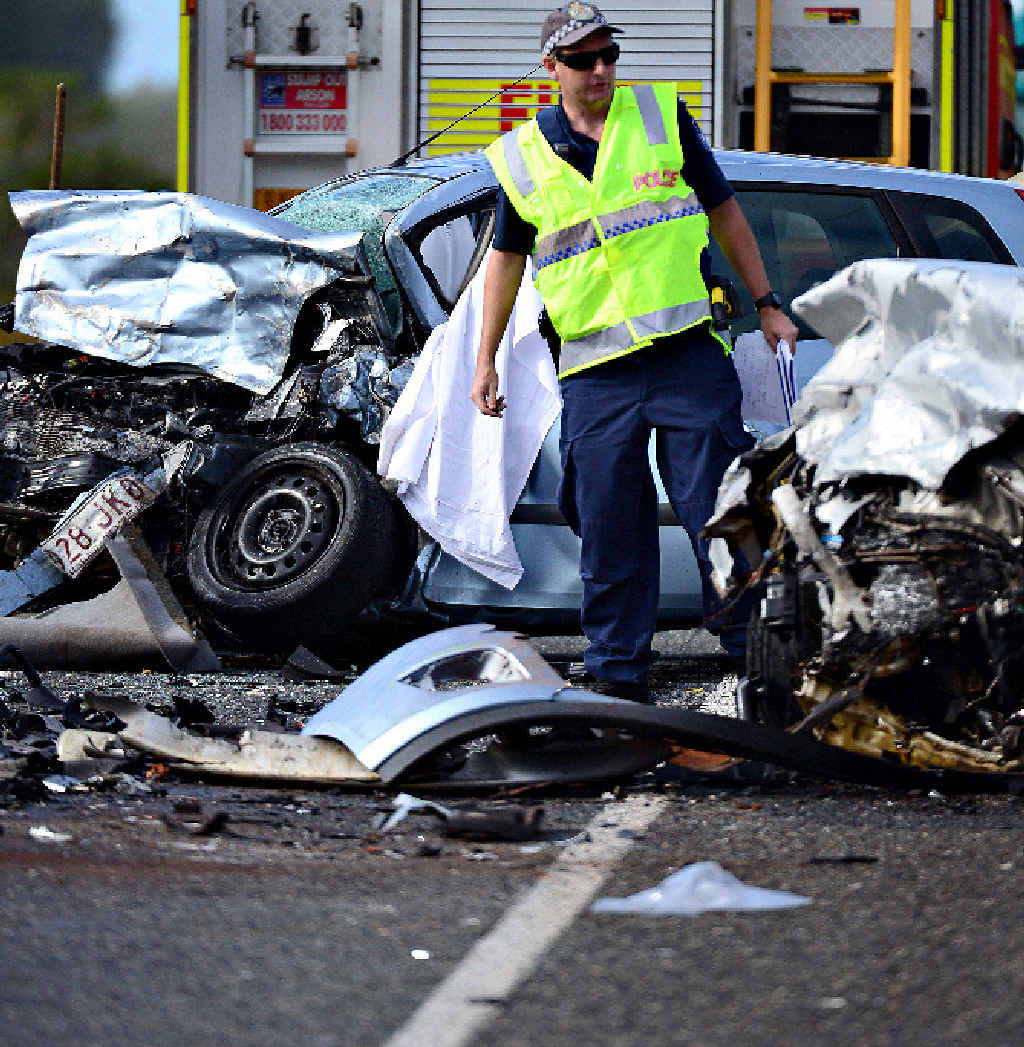 A police officer at the scene of a head-on crash on the Isis Hwy north of Childers where two Point Vernon fathers were killed. A police officer at the scene of a head-on crash on the Isis Hwy north of Childers where two Point Vernon fathers were killed.