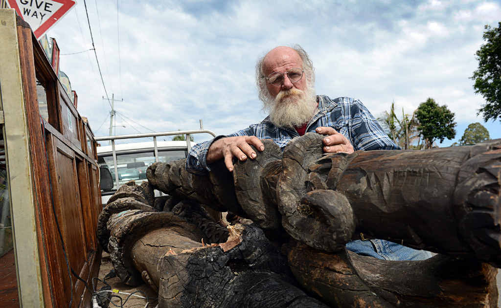 MAIN PICTURE: Michael Balderstone with totem poles rescued from the ruins of the Nimbin Museum and surrounding businesses destroyed by fire last month. MAIN PICTURE: Michael Balderstone with totem poles rescued from the ruins of the Nimbin Museum and surrounding businesses destroyed by fire last month.
