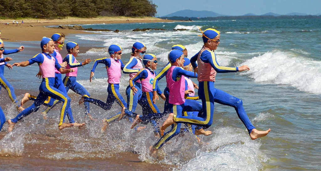 MAKING A SPLASH: Tannum Sands Surf Life Saving Club competitors charge over the breakers. MAKING A SPLASH: Tannum Sands Surf Life Saving Club competitors charge over the breakers.