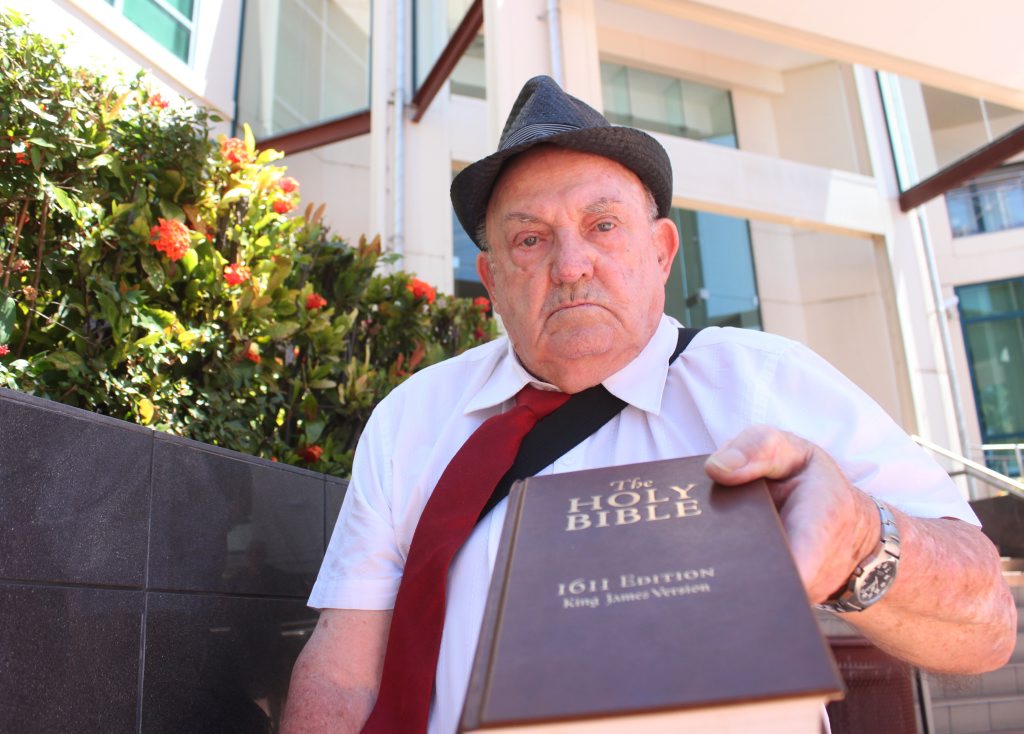 Ron Gallagher thrusts his bible forward outside the Rockhampton court house. He made an application in the Rockhampton Supreme Court yesterday. Photo: Austin King / The Morning Bulletin Ron Gallagher thrusts his bible forward outside the Rockhampton court house. He made an application in the Rockhampton Supreme Court yesterday. Photo: Austin King / The Morning Bulletin