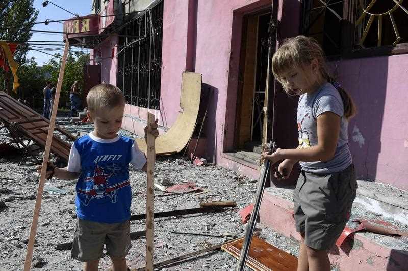 Children play in the rubble of their house on September 7, 2014 after an overnight bombing attack, near an Ukrainian army checkpoint in the outskirts of the key southeastern port city of Mariupol. Children play in the rubble of their house on September 7, 2014 after an overnight bombing attack, near an Ukrainian army checkpoint in the outskirts of the key southeastern port city of Mariupol.