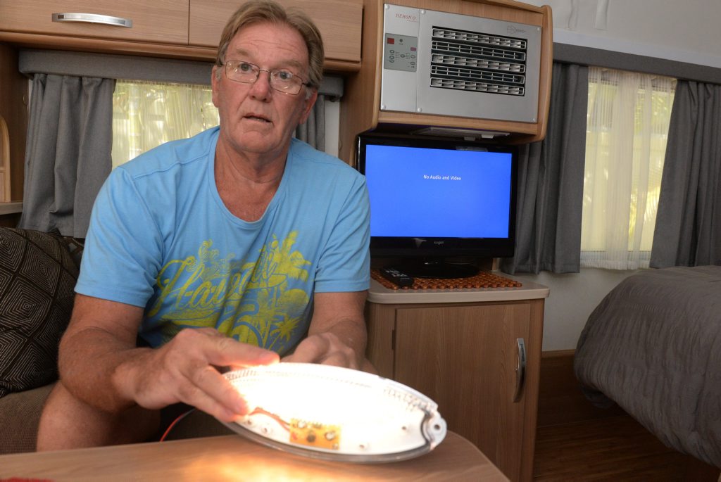 NO RECEPTION: Phil Shapcott demonstrates the effect his LED caravan lights have on his TV reception. Photo: Mike Knott / NewsMail NO RECEPTION: Phil Shapcott demonstrates the effect his LED caravan lights have on his TV reception. Photo: Mike Knott / NewsMail