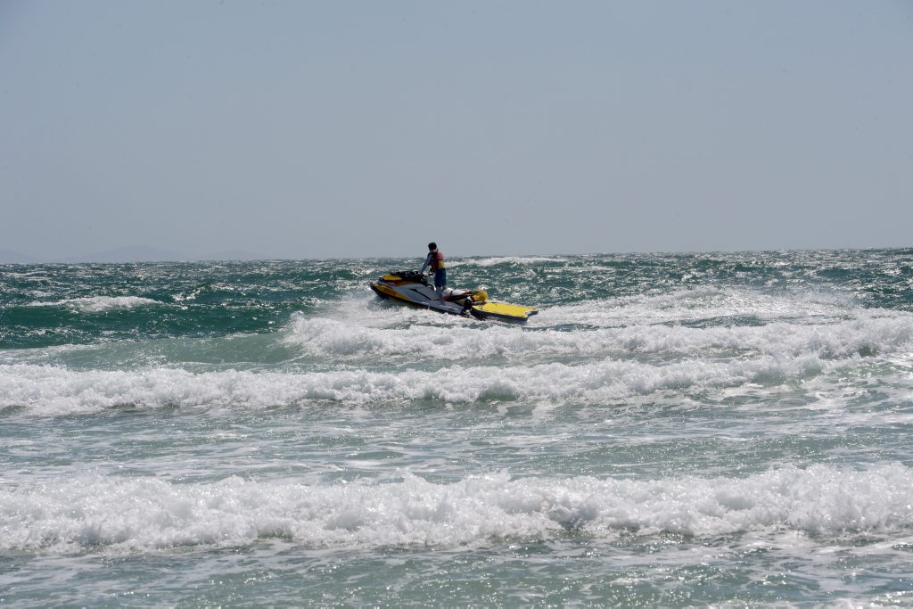 Jetskis patrol the beach on jetski in rough conditions the day after a fatal shark attack. Photo Cathy Adams / The Northern Star Jetskis patrol the beach on jetski in rough conditions the day after a fatal shark attack. Photo Cathy Adams / The Northern Star