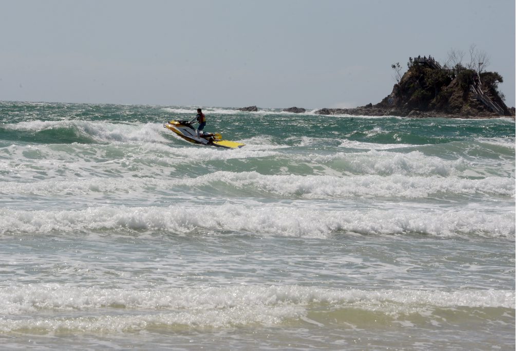 Jetskis patrol the beach on jetski in rough conditions at Clarkes Beach, Byron Bay the day after a fatal shark attack. Jetskis patrol the beach on jetski in rough conditions at Clarkes Beach, Byron Bay the day after a fatal shark attack.