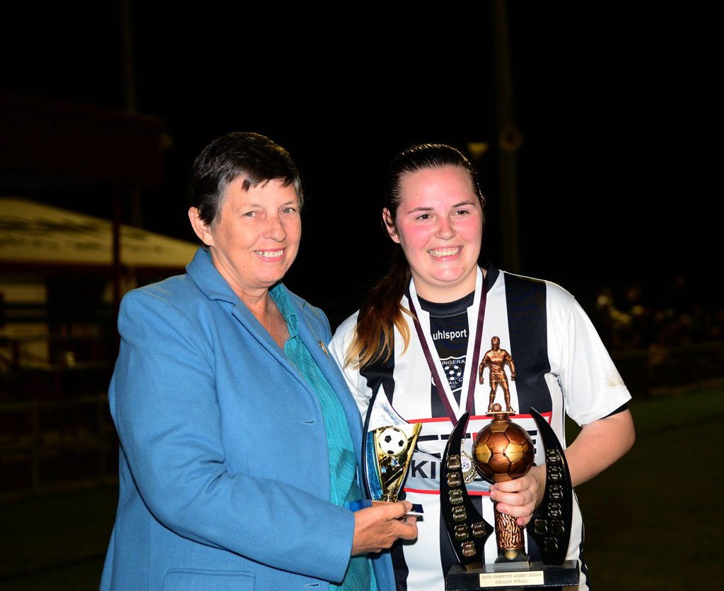 2014 WINNER: Kim Tominich presents Bingera captain Madelyn McCracken the Division 1 premiership trophy at Martens Oval after beating Moore Park 2-1. Photo: Ben Turnbull / NewsMail 2014 WINNER: Kim Tominich presents Bingera captain Madelyn McCracken the Division 1 premiership trophy at Martens Oval after beating Moore Park 2-1. Photo: Ben Turnbull / NewsMail