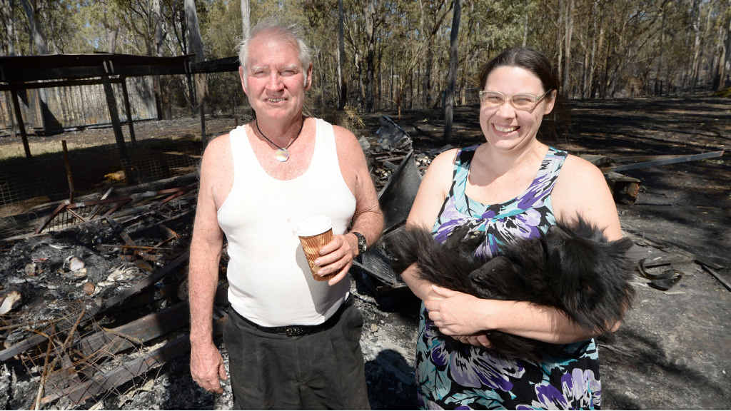 THANKFUL: Despite losing a caravan and the contents of a shipping container to fire, Ross Allan and his daughter Aleisa are happy they did not lose their home. Virtually nothing remains of a caravan (below) engulfed by fire. THANKFUL: Despite losing a caravan and the contents of a shipping container to fire, Ross Allan and his daughter Aleisa are happy they did not lose their home. Virtually nothing remains of a caravan (below) engulfed by fire.