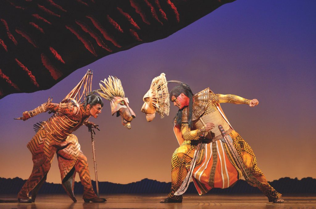 Rob Collins, left, as Scar and Josh Quong Tart as Mufasa in The Lion King. Rob Collins, left, as Scar and Josh Quong Tart as Mufasa in The Lion King.