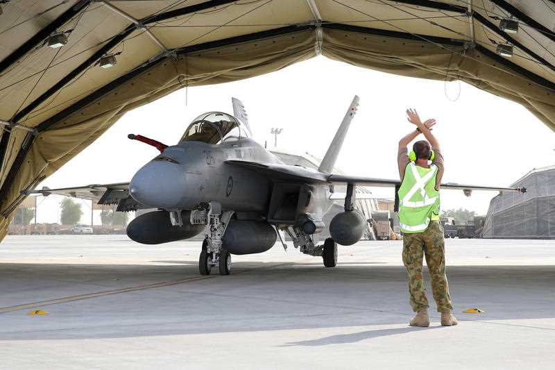 Supplied image obtained Wednesday, Sept. 24, 2014 of A Royal Australian Air Force airman marshals a RAAF F/A-18F Super Hornet aircraft into a hanger in the Middle East. The Australian Defence Force Air Task Group (ATG) has arrived at Australia’s main support base in the Middle East. Supplied image obtained Wednesday, Sept. 24, 2014 of A Royal Australian Air Force airman marshals a RAAF F/A-18F Super Hornet aircraft into a hanger in the Middle East. The Australian Defence Force Air Task Group (ATG) has arrived at Australia’s main support base in the Middle East.