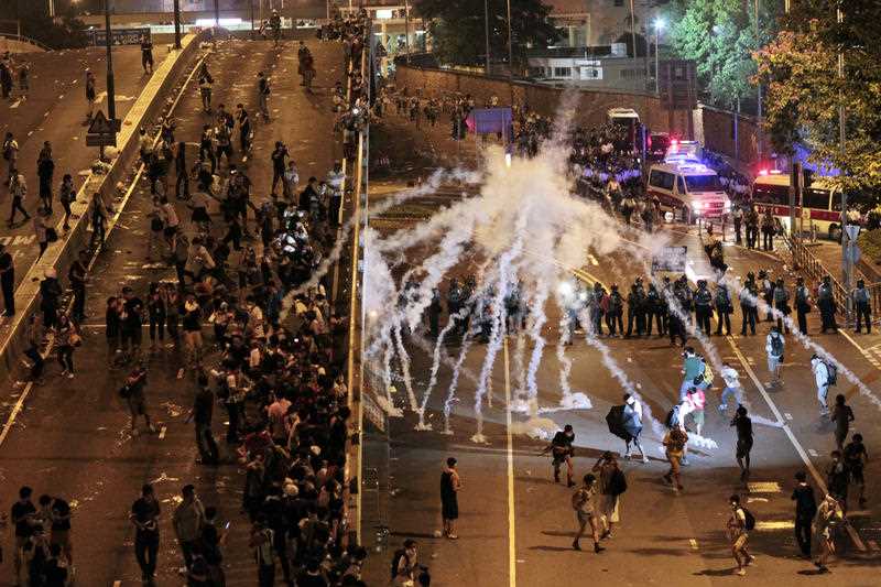 Riot police fire tear gas on student protesters occupying streets surrounding the government headquarters in Hong Kong, early Monday, Sept. 29, 2014. Pro-democracy demonstrators defied onslaughts of tear gas and appeals from Hong Kong's top leader to go home, as the protests over Beijing's decision to limit political reforms expanded across the city early Monday. Riot police fire tear gas on student protesters occupying streets surrounding the government headquarters in Hong Kong, early Monday, Sept. 29, 2014. Pro-democracy demonstrators defied onslaughts of tear gas and appeals from Hong Kong's top leader to go home, as the protests over Beijing's decision to limit political reforms expanded across the city early Monday.