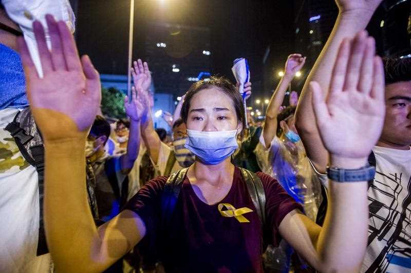 A demonstrator gestures opposite policemen during a pro-democracy protest in Hong Kong on September 28, 2014. A demonstrator gestures opposite policemen during a pro-democracy protest in Hong Kong on September 28, 2014.