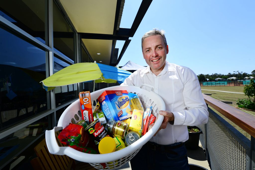 GIVING BACK: Sean Choat with the gift basket for house fire victim Ricky Murphy. GIVING BACK: Sean Choat with the gift basket for house fire victim Ricky Murphy.