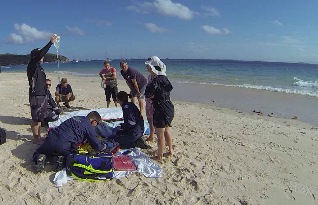 ON SCENE: Paramedics treat a woman on Great Keppel Island after a boating accident on Saturday. ON SCENE: Paramedics treat a woman on Great Keppel Island after a boating accident on Saturday.