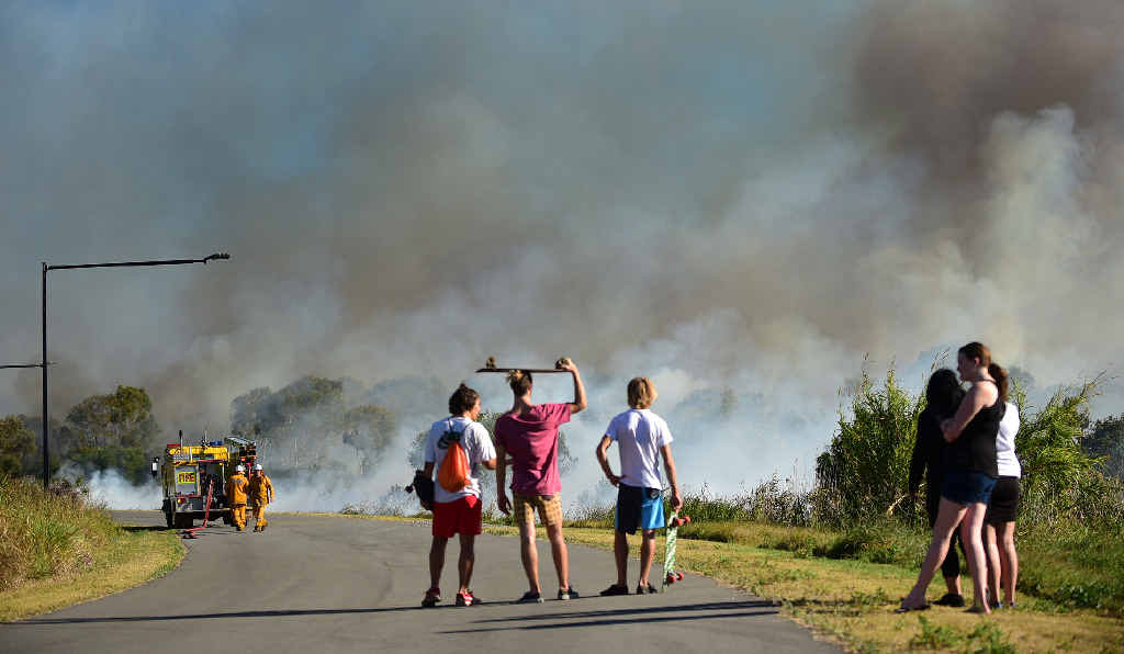 WHERE THERE’S SMOKE ... Young and old stopped to watch from Girraween Sports Complex as fire crews fought a huge bushfire at Sunrise Beach yesterday. Authorities feared the fire could threaten million-dollar homes nearby. WHERE THERE’S SMOKE ... Young and old stopped to watch from Girraween Sports Complex as fire crews fought a huge bushfire at Sunrise Beach yesterday. Authorities feared the fire could threaten million-dollar homes nearby.