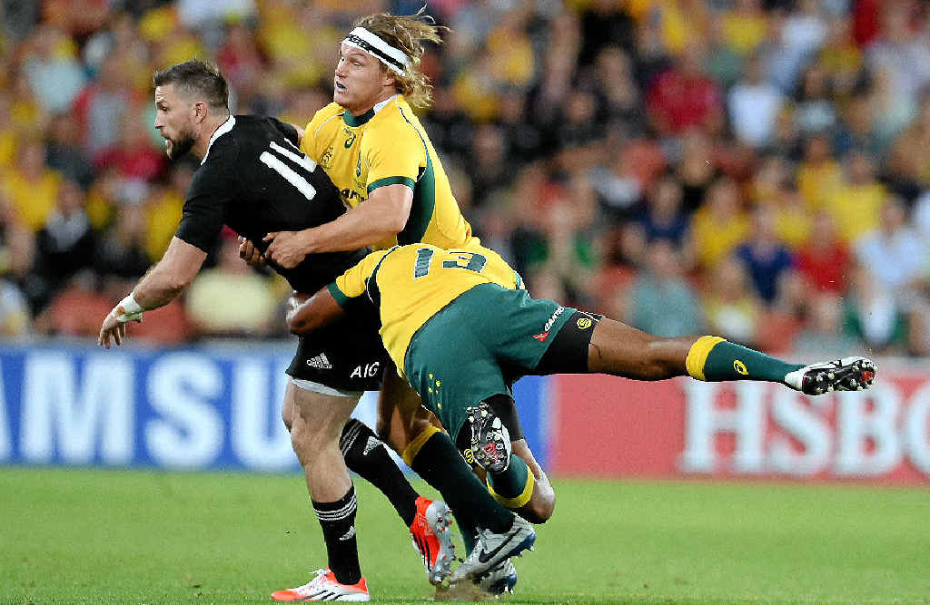 GOTCHA: Wallabies captain Michael Hooper, centre, and teammate Tevita Kuridasni tackle the All Blacks’ Cory Jane in Brisbane last night. GOTCHA: Wallabies captain Michael Hooper, centre, and teammate Tevita Kuridasni tackle the All Blacks’ Cory Jane in Brisbane last night.
