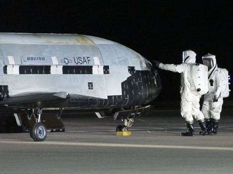 Technicians examining the X-37B unmanned spaceplane shortly after landing at Vandenberg Air Force Base, Calif Technicians examining the X-37B unmanned spaceplane shortly after landing at Vandenberg Air Force Base, Calif