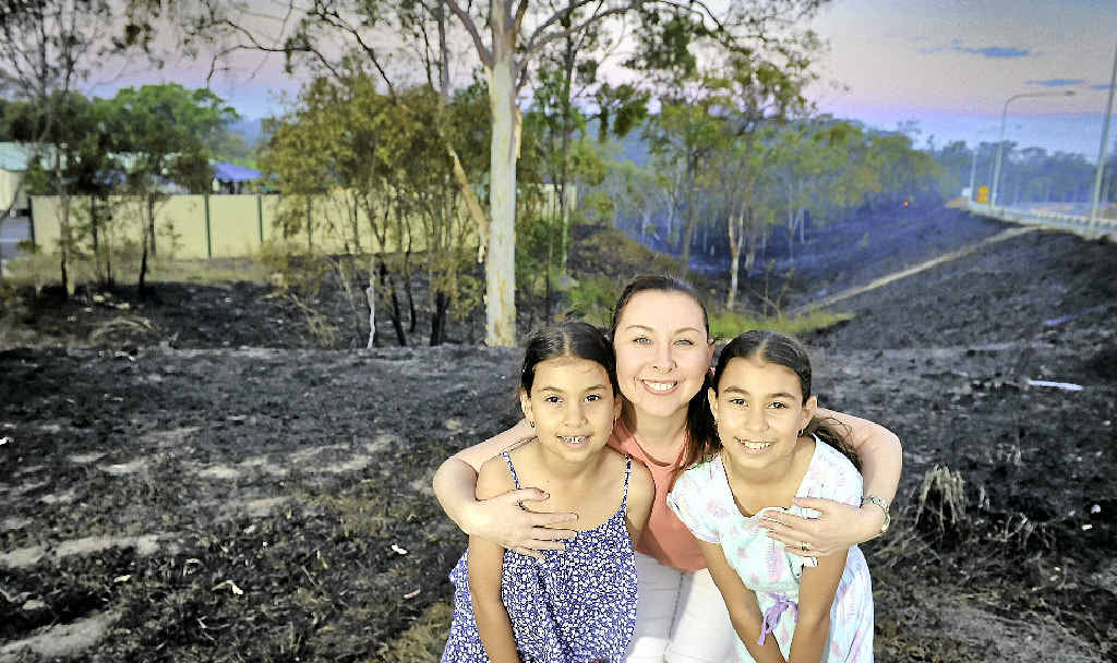 WHAT A DAY: Terri Samuel was relieved to hug her two daughters, Jayde, 9, and Maddison, 12, on Tuesday after their school was evacuated during a wild fire. Fire crews responded quickly to the blaze and kept several properties safe. WHAT A DAY: Terri Samuel was relieved to hug her two daughters, Jayde, 9, and Maddison, 12, on Tuesday after their school was evacuated during a wild fire. Fire crews responded quickly to the blaze and kept several properties safe.