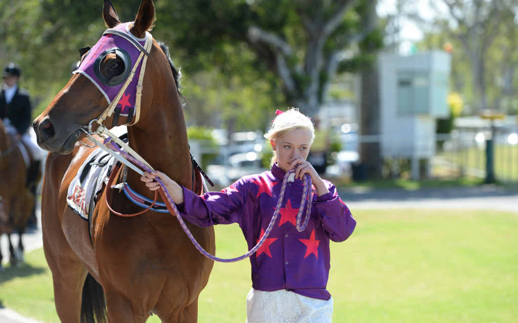 SOLEMN GOODBYE: Rockhampton’s Zoe White leads a horse in the entourage at renowned jockey Carly-Mae Pye’s funeral service at Callaghan Park. SOLEMN GOODBYE: Rockhampton’s Zoe White leads a horse in the entourage at renowned jockey Carly-Mae Pye’s funeral service at Callaghan Park.