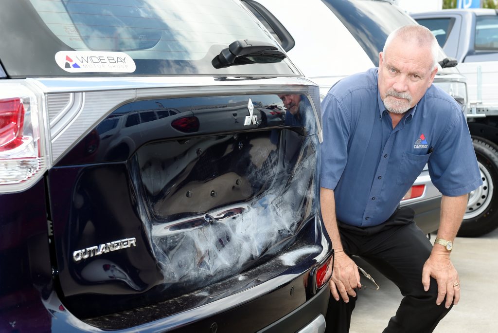 General sales manager Adrian Eustice looks over the damage to a Mitsubishi Outlander following an attack by vandals. General sales manager Adrian Eustice looks over the damage to a Mitsubishi Outlander following an attack by vandals.