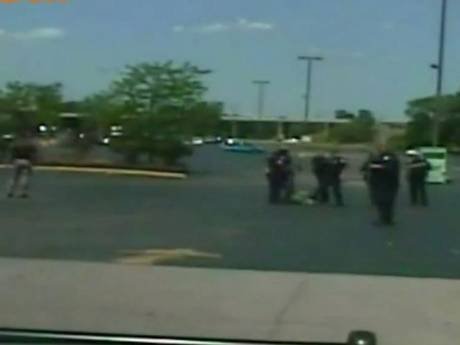 Police officers attempting to handcuff Mr Hall after shooting him Police officers attempting to handcuff Mr Hall after shooting him