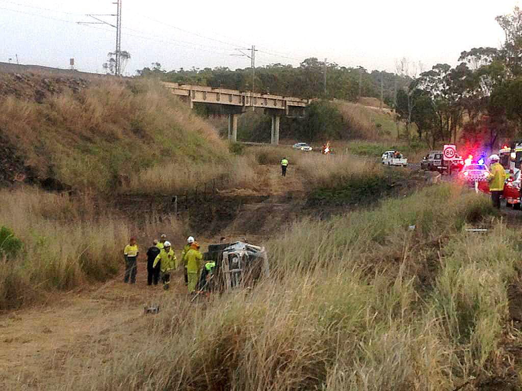 Emergency service personnel at the scene of a single vehicle crash on Gladstone Benaraby Road. Emergency service personnel at the scene of a single vehicle crash on Gladstone Benaraby Road.