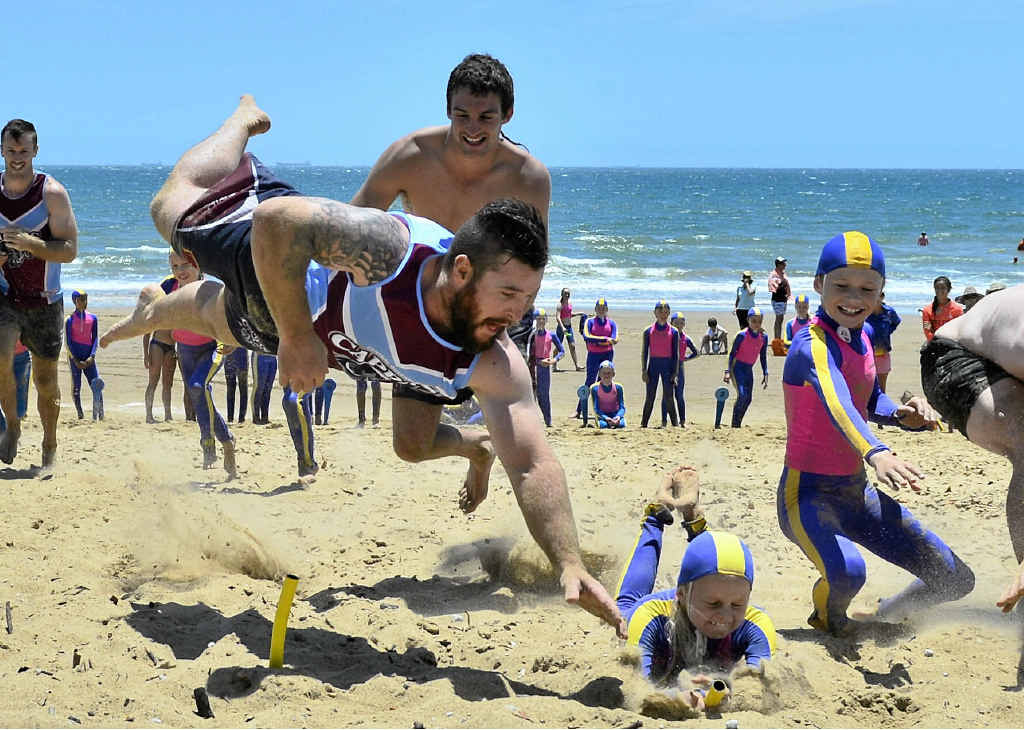 MINE! Peter Gallen dives for a flag but is beaten by Lily McClure, 9, at Tannum Sands beach for a training session including the Central Queensland Capras and the Nippers. MINE! Peter Gallen dives for a flag but is beaten by Lily McClure, 9, at Tannum Sands beach for a training session including the Central Queensland Capras and the Nippers.
