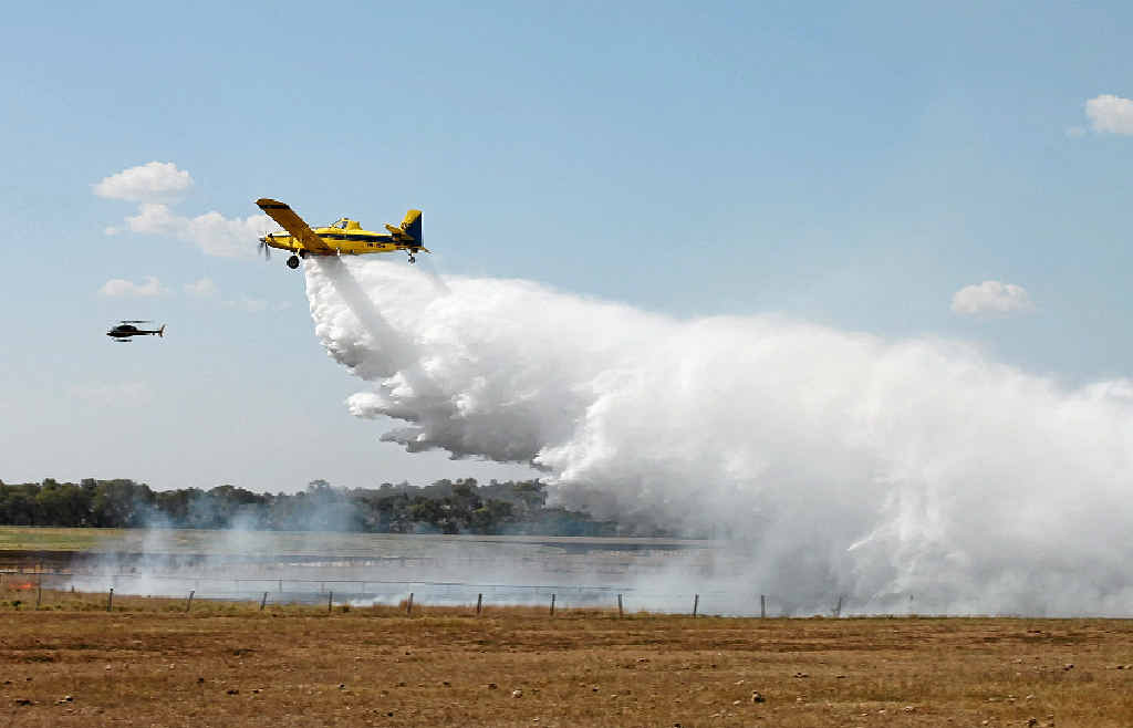 AERIAL SUPPORT: A water bomber dumps its load on the fire burning in a paddock owned by Lyndhurst Stud.
