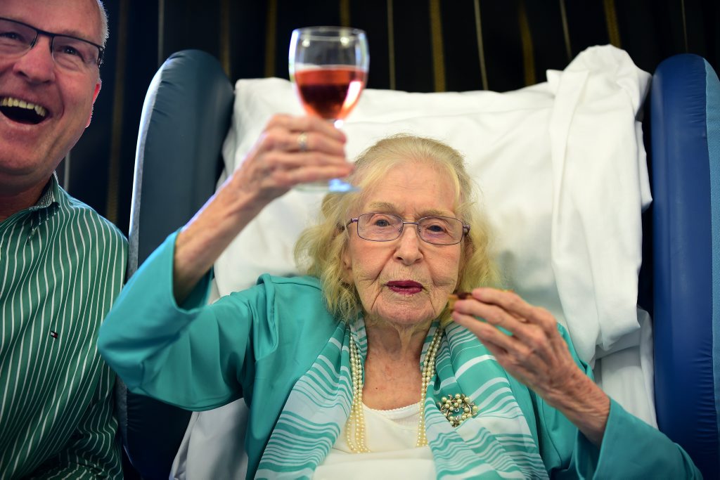 Image for sale: Monica Guy turned 108 surrounded by family and friends. Mayor, Mark Jamieson shares a cheers and a laugh with Monica. Photo: Cade Mooney / Sunshine Coast Daily