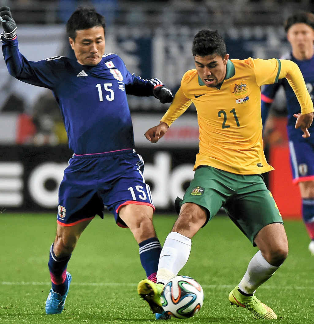 PROMISING FUTURE: Massimo Luongo tussles with Yasuyuki Konno of Japan at Nagai Stadium. PROMISING FUTURE: Massimo Luongo tussles with Yasuyuki Konno of Japan at Nagai Stadium.