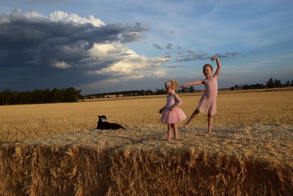 Florence (left) and Olivia Nason dance in the paddock on their Bringalily farm. Florence (left) and Olivia Nason dance in the paddock on their Bringalily farm.