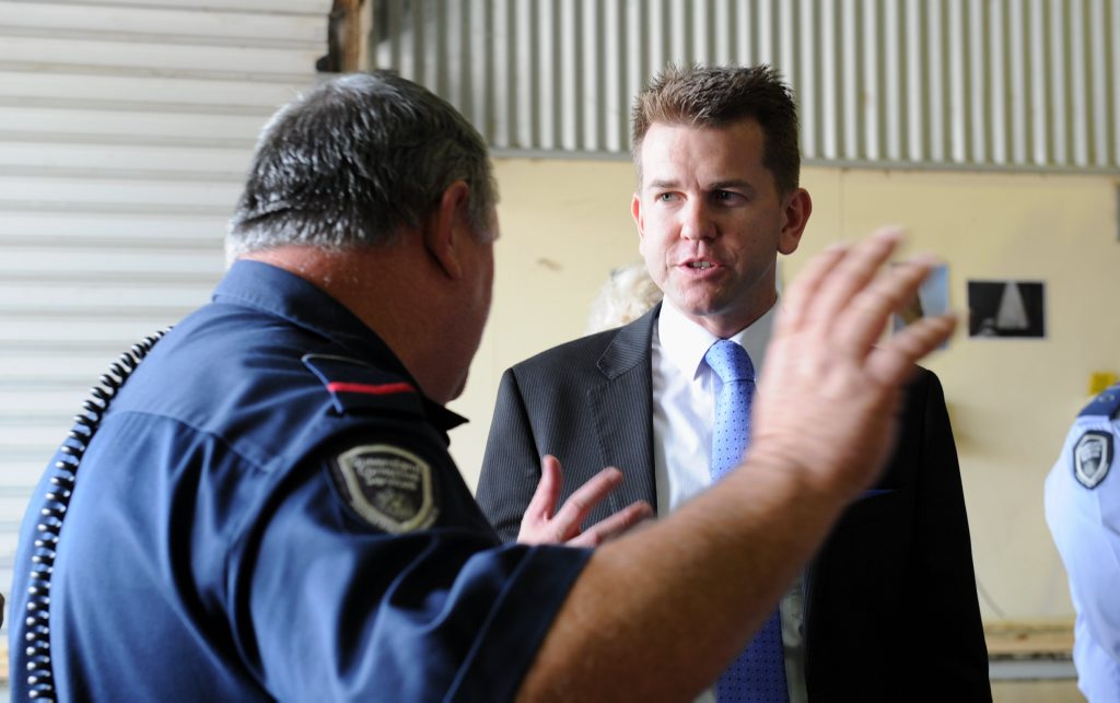 A Maryborough Correctional Centre officer gives Queensland's Attorney General Jarrod Bleijie a run-down of one of the workshops in the facility. A Maryborough Correctional Centre officer gives Queensland's Attorney General Jarrod Bleijie a run-down of one of the workshops in the facility.