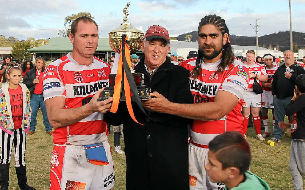 PREMIERS: Killarney Cutters vice-captain Leejay Cooper and captain-coach John Trindall with BRL president Neil “Casey” O’Connor after the 2014 grand final. PREMIERS: Killarney Cutters vice-captain Leejay Cooper and captain-coach John Trindall with BRL president Neil “Casey” O’Connor after the 2014 grand final.