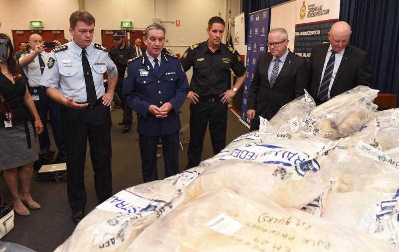 Senior police and customs officers inspect some of the seized drugs in one of the largest drug busts in the country's history, worth up to 1.28 billion USD, in Sydney on November 29, 2014. Australian Federal Police said six men were charged over their involvement in the attempted importation of almost three tonnes of MDMA and crystal methamphetamine, also known as ice, into Sydney. Senior police and customs officers inspect some of the seized drugs in one of the largest drug busts in the country's history, worth up to 1.28 billion USD, in Sydney on November 29, 2014. Australian Federal Police said six men were charged over their involvement in the attempted importation of almost three tonnes of MDMA and crystal methamphetamine, also known as ice, into Sydney.