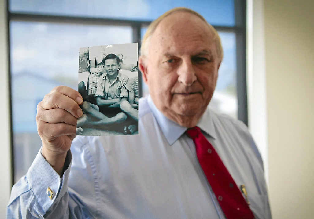 LOOKING BACK: Bill McMillan with a photo of himself at 12 years old, when he decided to be a lawyer. LOOKING BACK: Bill McMillan with a photo of himself at 12 years old, when he decided to be a lawyer.