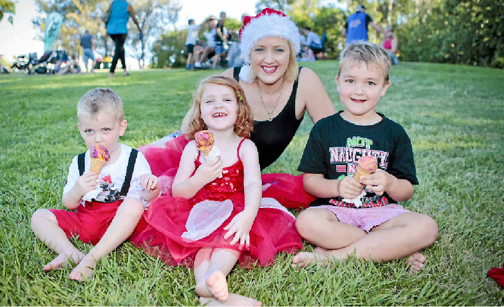 EXCITEMENT BUILDING: Danielle Eilola and her three kids Rylan, 2, Gracie, 3, and Nate, 4, enjoy an ice cream at the Carols by Candlelight. EXCITEMENT BUILDING: Danielle Eilola and her three kids Rylan, 2, Gracie, 3, and Nate, 4, enjoy an ice cream at the Carols by Candlelight.