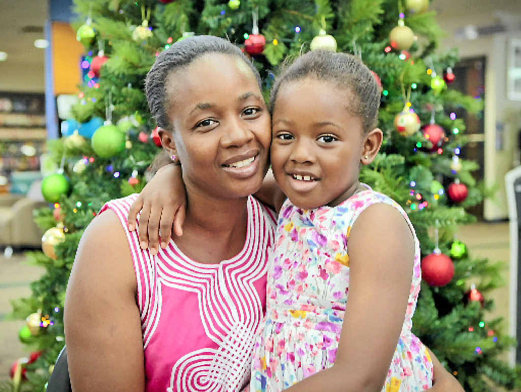 PLEASANT CHANGE: Joyce Koroma and her daughter Elia, 5, celebrate Christmas early at WIN’s Port City Language Cafe. PLEASANT CHANGE: Joyce Koroma and her daughter Elia, 5, celebrate Christmas early at WIN’s Port City Language Cafe.