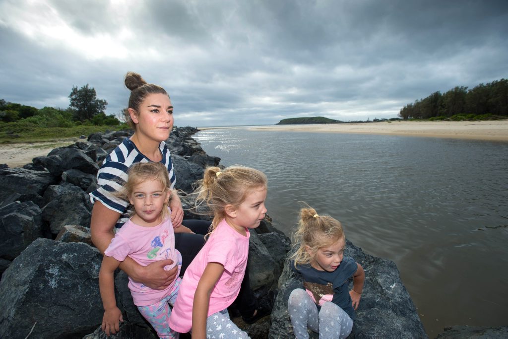 RELUCTANT HERO: Nikki Williams with her three-year-old daughters Harlow, Billi and Ruby at the scene of Sunday’s rescue in Coffs Creek.
RELUCTANT HERO: Nikki Williams with her three-year-old daughters Harlow, Billi and Ruby at the scene of Sunday’s rescue in Coffs Creek.