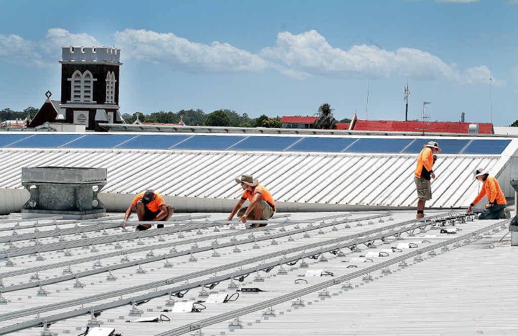 Workers from Watkins Electrical, Jaden van Tonder, Henrico van Tonder, Ben Cook and Brodie Smith begin the process of laying 400 solar panels on the roof of Station Square. Workers from Watkins Electrical, Jaden van Tonder, Henrico van Tonder, Ben Cook and Brodie Smith begin the process of laying 400 solar panels on the roof of Station Square.