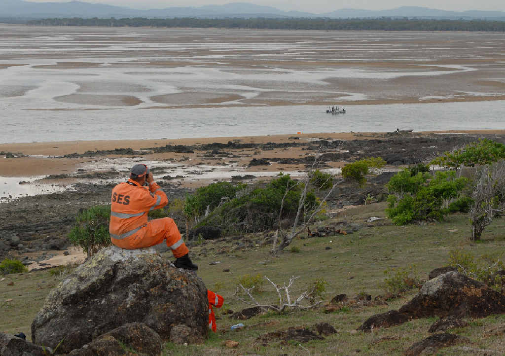 STILL SEARCHING: Mackay SES volunteers Damien Wood and Rik De Meer (on the ground) keep an eye out for signs of missing man Neville Ohl as the police boat searches at Notch Point. STILL SEARCHING: Mackay SES volunteers Damien Wood and Rik De Meer (on the ground) keep an eye out for signs of missing man Neville Ohl as the police boat searches at Notch Point.
